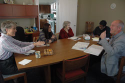 Rita Bohman, left, administrator of religious education (ARE) at St. John the Evangelist Parish in Enochsburg, speaks with archdiocesan director of catechesis Kenneth Ogorek, right, during a meeting on Nov. 16 at the Batesville Deanery parish’s rectory. Also attending the meeting were, from left, Stacey Weisenbach, ARE at St. Maurice Parish in St. Maurice, Bertha Patterson, ARE at St. Anne Parish in Hamburg, and Father George Joseph Nangachiveettil, administrator of the three parishes.