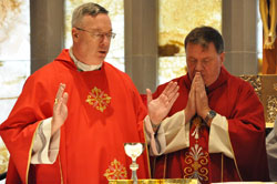 Bishop Christopher J. Coyne, apostolic administrator, left, prays part of a eucharistic prayer while Archbishop Joseph W. Tobin prays in silence during an Oct. 19 Mass at the St. Augustine Home for the Aged Chapel in Indianapolis. The liturgy with the Little Sisters of the Poor and elderly residents of the home was among Archbishop Tobin’s first pastoral visits after his appointment was announced by Pope Benedict XVI on Oct. 18. See related story on page 47. (Photo by Mary Ann Garber)