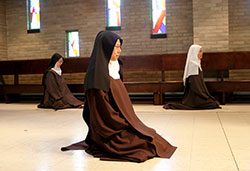 Discalced Carmelite Sister Marianna So, center, kneels in prayer in the chapel of the Monastery of St. Joseph in Terre Haute. (Photo courtesy of Monastery of St. Joseph)