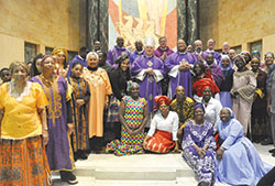 Cardinal Joseph W. Tobin poses with the concelebrating priests and members of the African Catholic Community toward the end of the annual African Mass at St. Rita Church in Indianapolis on Dec. 4. (Photo by Natalie Hoefer) 