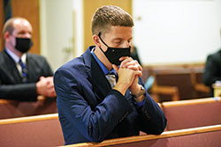 Seminarian Jack Wright, a member of St. Elizabeth Ann Seton Parish in Richmond, kneels in prayer during an Aug. 3 Mass in the chapel of Our Lady of Fatima Retreat House in Indianapolis. The liturgy was part of the archdiocesan seminarians’ annual convocation. (Photo by Sean Gallagher)