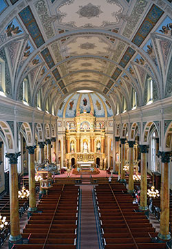 The sanctuary of St. Joseph Shrine in St. Louis boasts a three-tier “Altar of Answered Prayers,” the effort of parishioners in thanksgiving after a St. Joseph novena during a cholera epidemic in 1866. (Photo by Natalie Hoefer)