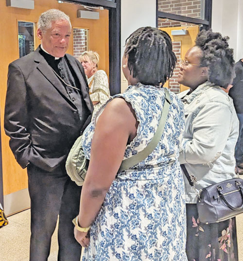 Retired Bishop Joseph N. Perry of Chicago, postulator for Father Augustus Tolton’s sainthood cause, speaks with Tolton film viewers outside Marian University Theater in Indianapolis on July 16. (Photo by Ann Margaret Lewis)