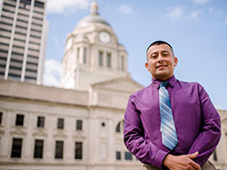 Alex Coreas poses in front of the Allen County Courthouse. He is now a Fort Wayne resident, thanks to the help of Catholic Charities.